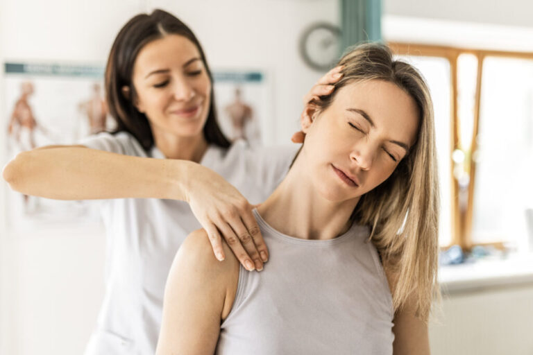 Young woman at physical therapy program feeling neck pain